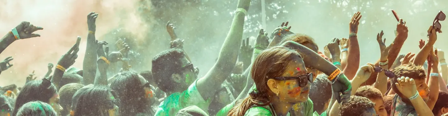 Grupa ludzi bawiąca się na festiwalu kolorów